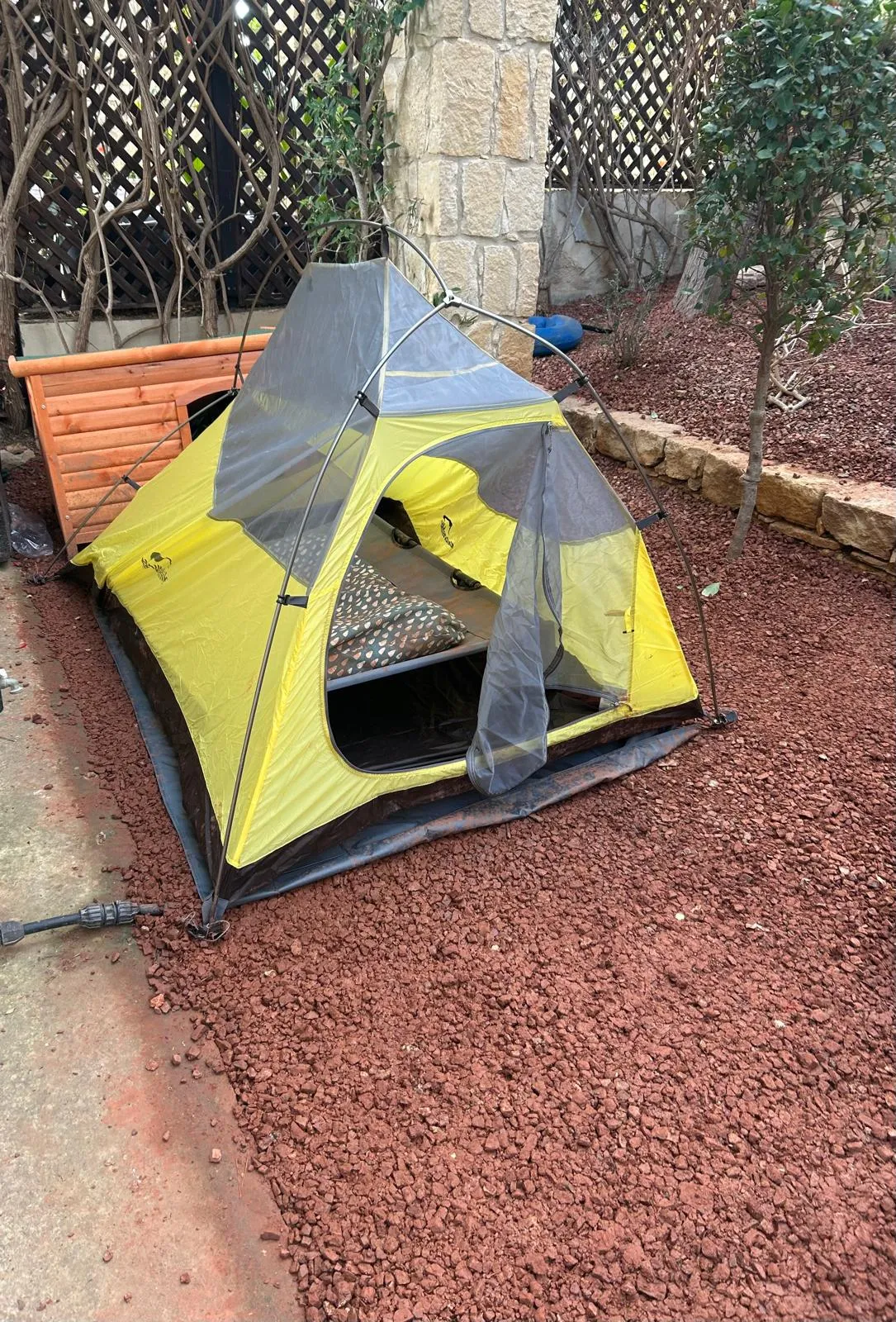 The NatureHike Cloud Up 2 tent, fully assembled in proper dome shape, in the gravel courtyard